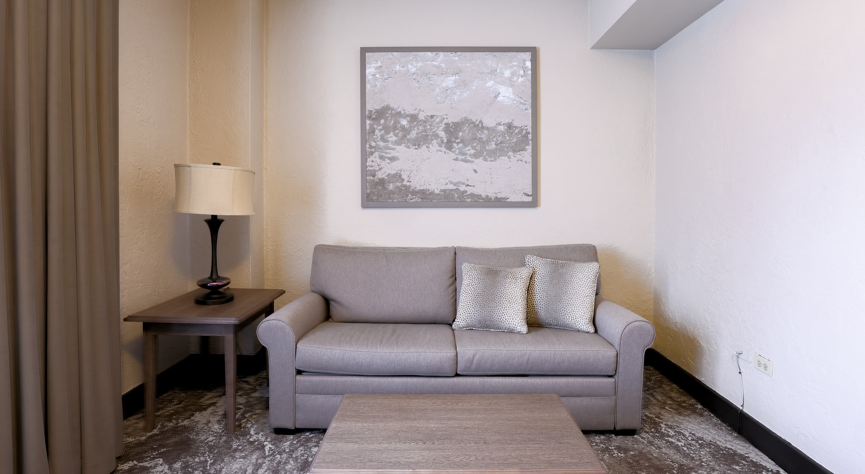 Seating area of one bedroom suite at Hotel Baker offering one of the best places to stay in St. Charles, IL